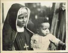 1935 Press Photo Coptic nun holds child at orphanage at Addis Ababa, Ethiopia picture