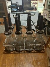 1940’S GLASS MOTOR OIL BOTTLES FULL SET OF 8 W/ ORIG WIRE CARRIER  SPOUTS & CAPS picture