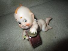 VINTAGE KEWPIE FIGURINE PLAYING THE DRUMS SIGNED ON BOTTOM WITH NUMBERS picture