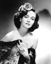 Teresa Wright with flowers in her hair as well as holding flowers- Old Photo picture