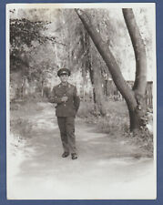 Beautiful boy soldier near a tree. Soviet soldier. Soviet Vintage Photo USSR picture