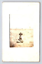 RPPC Boy Sitting on Ground on a Farm in Overalls Real Photo Postcard picture