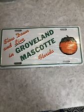 Slow Down And Live In Groveland Mascots Florida Vintage Metal Tag New In Plastic picture