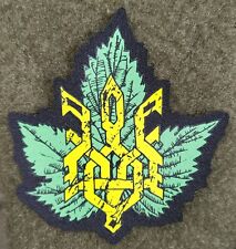Patch Ukrainian-Russian War Trizub on the Background of Viburnum Leaf. Rubber picture