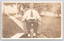 RPPC Man Sitting In Wicker Rocking Chair On Sidewalk c1910 Real Photo Postcard picture