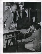 1955 Press Photo Dr. Franklin David as he inspects a Virgin fracture table picture