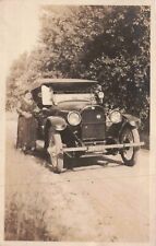 RPPC Woman Stands Next to Antique Car on Dirt Road Real Photo Vintage Postcard picture
