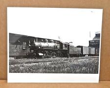 Photo: 1937 C&NW #1141 R-1 Type 4-6-0 With White Flags Extra At Grain Elevator picture