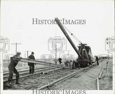 1941 Press Photo Union Pacific Railroad Crew Laying Train Tracks with Crane picture
