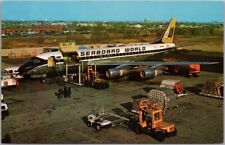 Vintage 1950s SEABOARD WORLD AIRLINES Postcard Freight Plane / Airport Scene picture
