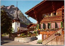 VINTAGE POSTCARD CONTINENTAL SIZE WOODEN CABIN IN VILLAGE OF GSTEIG SWITZERLAND picture