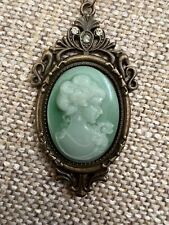 plastic green cameo with rhinestones w/ faux antique gold setting on chain picture