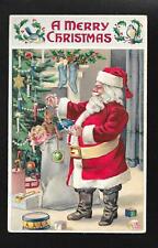 1909 Merry Christmas Santa Decorating Tree Embossed Postcard picture