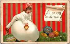 Embossed Easter Postcard Little Girl Climbing on Giant Egg Decorated Colored Egg picture
