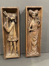 Pair of wood carved panels with musical figures.  12” tall.  picture