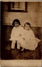 c1910 BABY AND VERY YOUNG GIRL POSE ORIENTAL RUG PORCH CYKO RPPC POSTCARD 38-72 picture