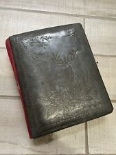 Empty antique velvet photo album with embossed deer on the cover picture
