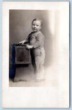 1907-1918 ERA RPPC SMILING CHILD IN OVERALLS*HANDS ON BOX PROP*AZO STAMP BOX picture