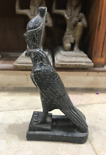 An ancient statue of the god Horus, heavy with a crown made of solid material picture