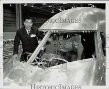 1968 Press Photo An official inspects the cockpit of a plane at plant picture