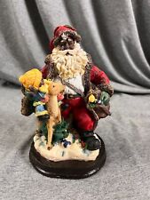 Black Santa Claus Figurine with Kid, Deer, and Toy Bag. picture