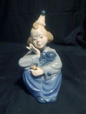 PAUL SEBASTIAN PORCELAIN SEATED CLOWN FIGURINE HOLDING A YELLOW FLOWER picture