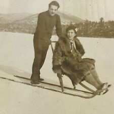 Vintage Sepia Photo Man Pushing Woman On Sled Sledding Winter Snow Outdoors picture
