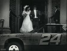 1991 Press Photo Newly married couple find race car as present after ceremony. picture