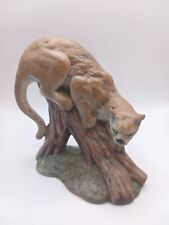 STATUE OF MOUNTAIN LION  ON TREE TRUNK picture