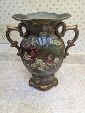 Vintage Cardinal Vase With Gold Accents On Forest Greenish Background picture
