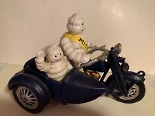 MICHILIN TIRE MAN ON TRIUMPH  MOTORCYCLE W/SIDECAR AND LITTLE MICHLIN KID IN IT picture