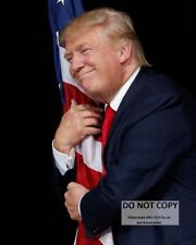 DONALD TRUMP HUGGING THE AMERICAN FLAG IN 2016 - 8X10 PHOTO (CP027) picture