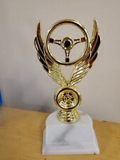 auto racing, car show, award or trophy winged wheel, about 7