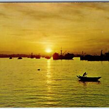 c1960s Singapore Sunrise Over Horizon Man in Row Boat Port Navy Ship Sun PC A227 picture