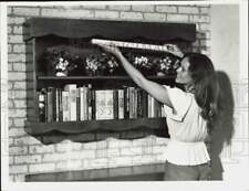 1979 Press Photo Woman arranging plants on shelf - lra62484 picture