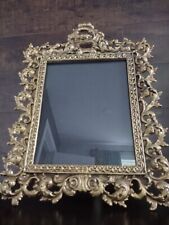 Antique cast iron gilded photo frame in Baroque style. picture