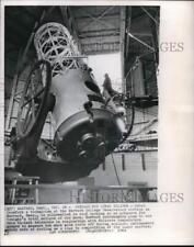 1964 Press Photo Technician silhouetted in roof of Harvard Observatory station. picture