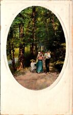 vintage postcard- Family walking along path in the woods c1900s unposted embos. picture