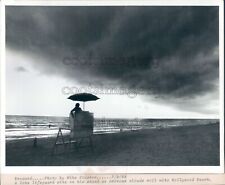 1989 Press Photo Lone Lifeguard Watches Storm Clouds Roll in Hollywood Beach FL picture