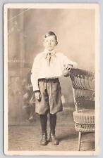 RPPC Young Boy with Boots in  Studio Standing By Chair c1910 Real Photo Postcard picture