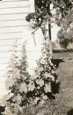 PP237 Vtg Photo YOUNG WOMAN STANDING IN HOLLY HOCKS c 1923 picture