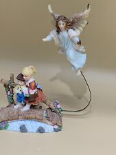 CUTE FIGURINE WITH TWO CHILDREN WITH AN ANGEL ABOVE picture