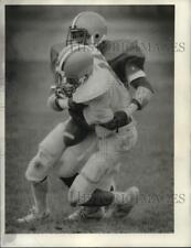 1985 Press Photo Football player (dark jersey) tackles player carrying the ball picture
