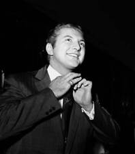 Musician and pianist Liberace is pictured adjusting his tie 1950s Old Photo picture