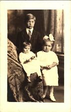 A Family Photo of A Baby, A Little Girl And Their Oldest Brother Postcard picture