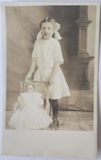 RPPC c1910 Young Girl With Vintage Doll In Chair Studio Photo Postcard picture