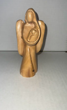 Olive wood angel statue carrying a child made in the Holy Land of Bethlehem picture
