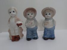 Vintage porcelain figurines. 2 Boys with hat and a bird. 1 Boy with basket. picture
