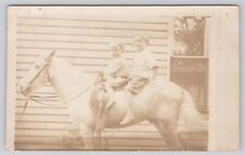 Two Young Children Sitting on White Horse Beside House c1904-1920s RPPC Postcard picture