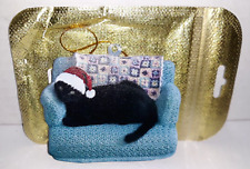 Black Cat with Santa Hat Ornament Sitting on Couch with Afghan Christmas Holiday picture